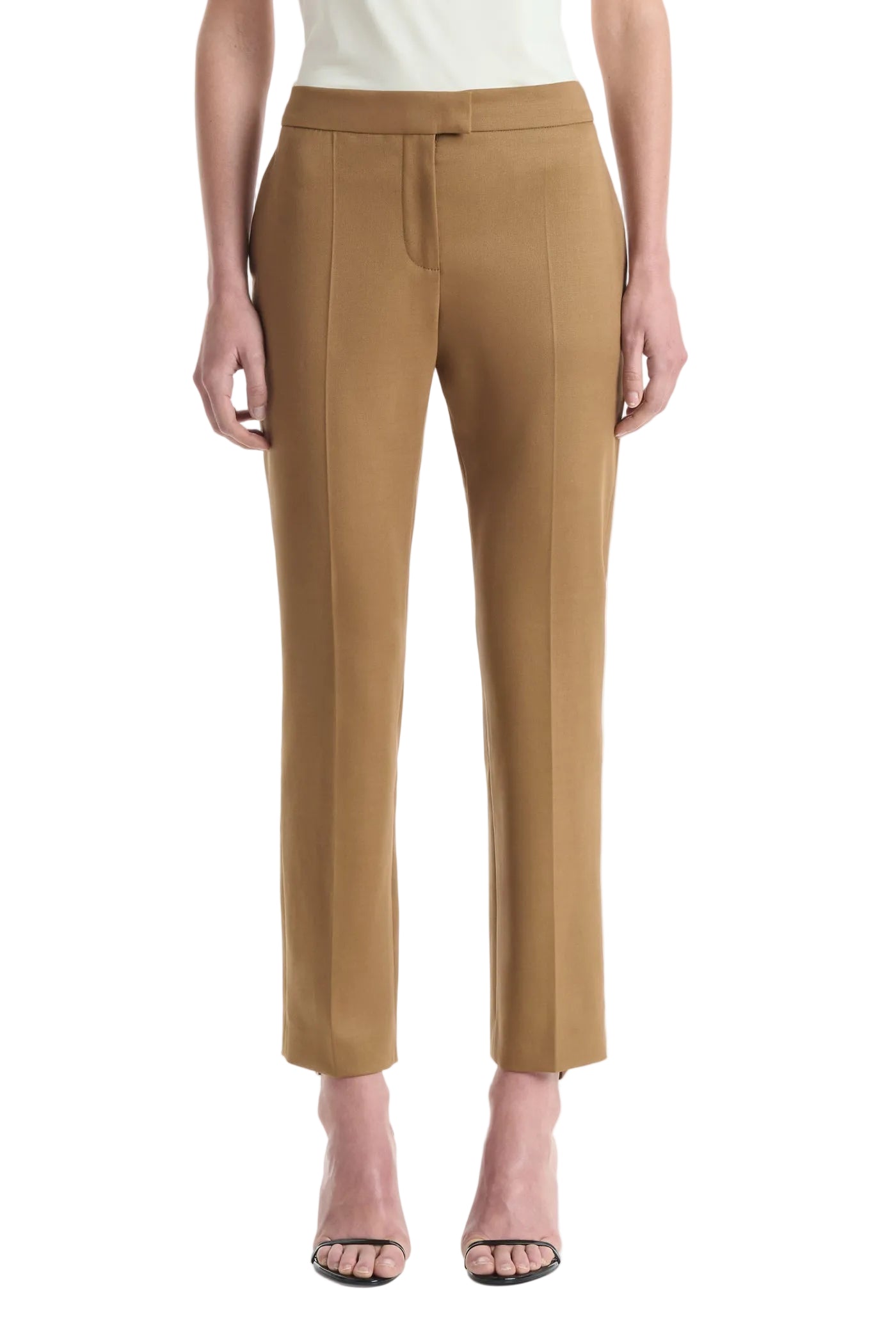 Wearing the Altuzarra Todd Pant in tan, styled with open-toe heels, this individual stands against a plain white background.