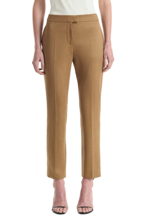 Wearing the Altuzarra Todd Pant in tan, styled with open-toe heels, this individual stands against a plain white background.