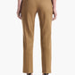 A person wearing the Altuzarra Todd Pant—tailored tan dress pants with a straight leg—paired with black high heels, shown from the back against a white background.