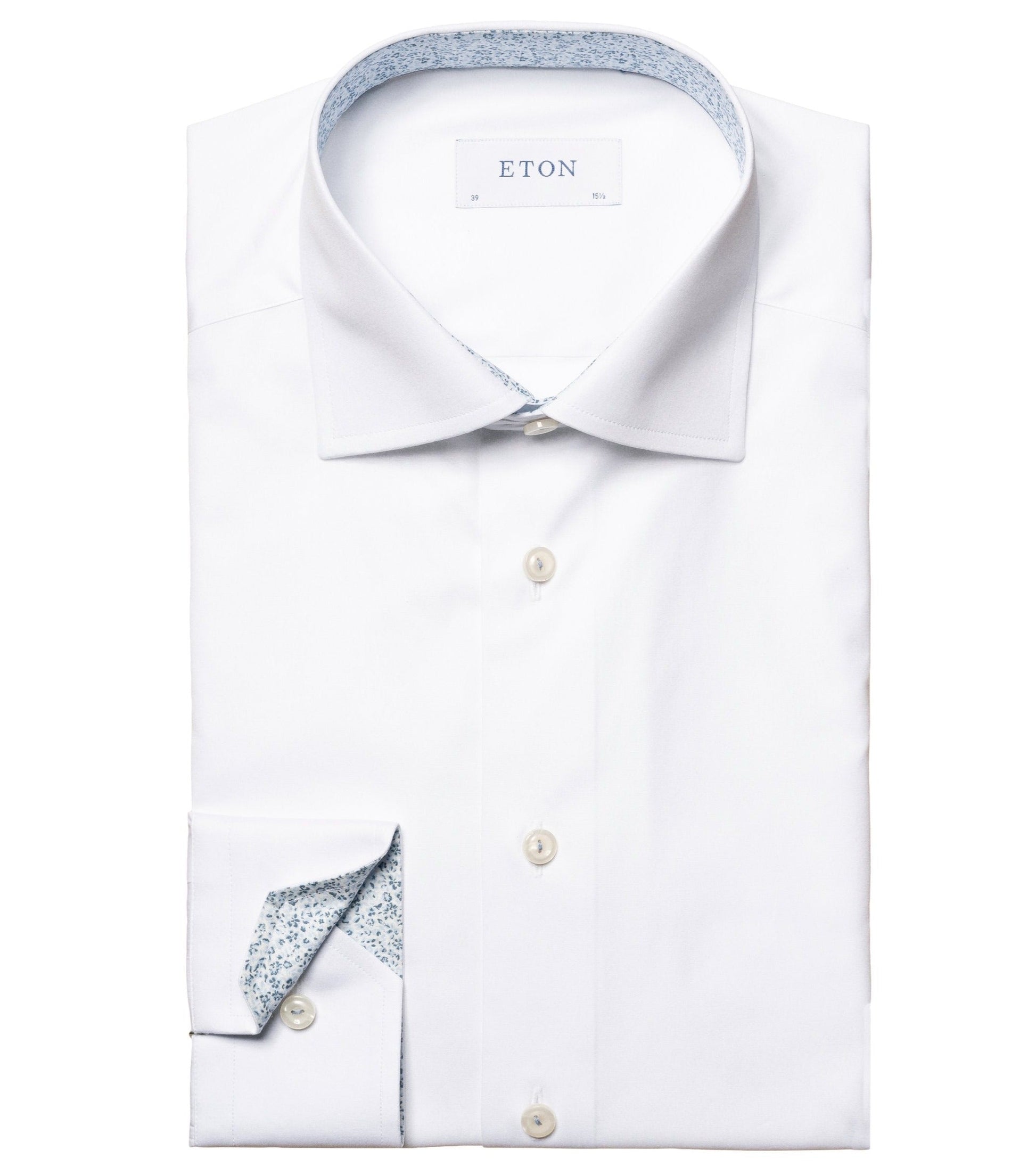 A new Eton White Solid Floral Contrast Poplin shirt with a floral micro print on the inside collar and cuffs, laid out flat and buttoned up.