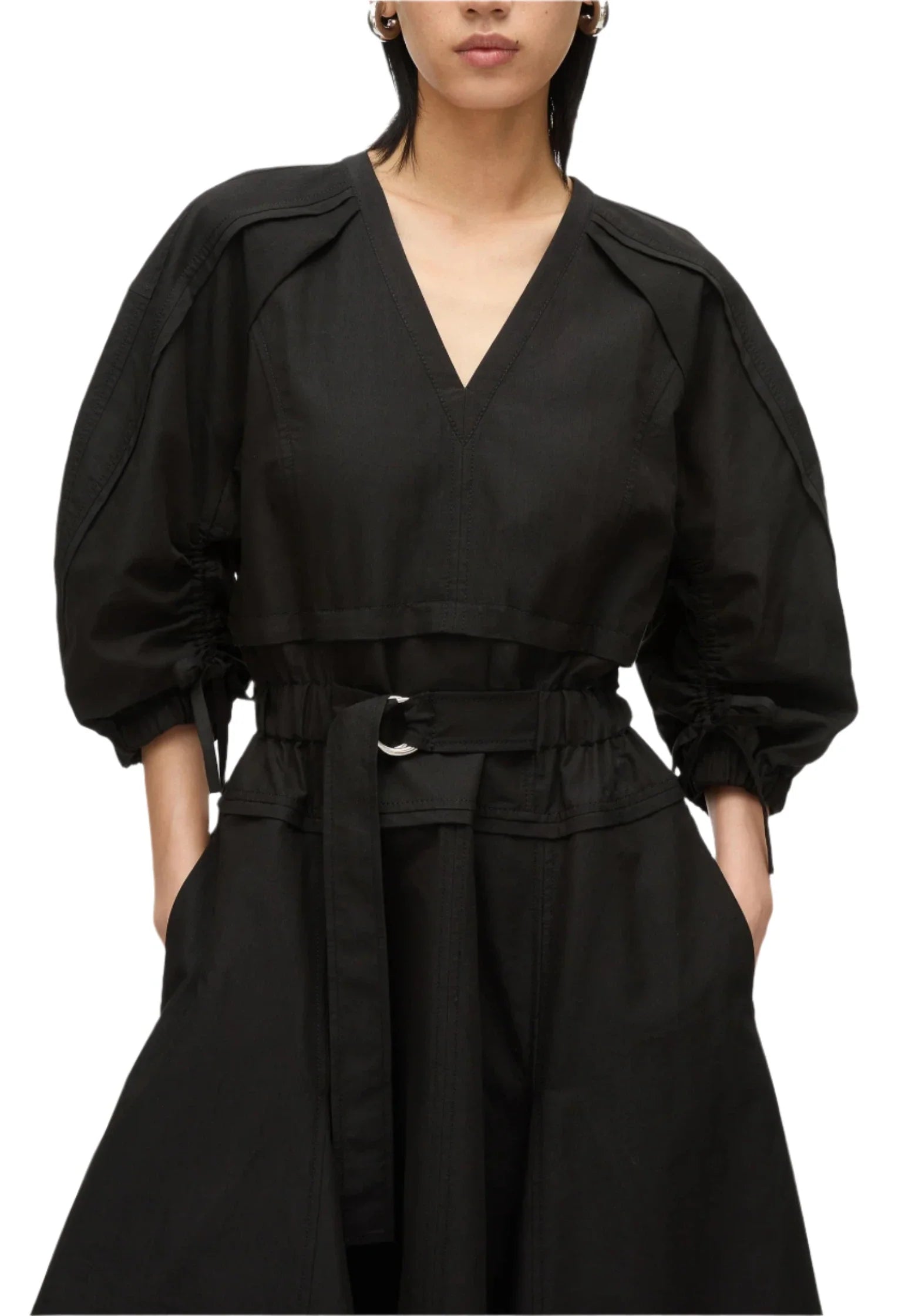 A person wearing the 3.1 Phillip Lim V Neck Dress with Gathered Sleeves, crafted from luxurious Italian ottoman cotton and featuring a stylish belt and gathered sleeves.