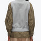 A person is seen from behind wearing the 3.1 Phillip Lim Layered Vest Ruched Sleeve Shirt paired with beige pants, set against a plain background.