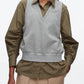A person wears the 3.1 Phillip Lim Layered Vest Ruched Sleeve Shirt, styled with beige pants featuring large pockets.