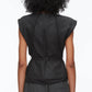 A person with curly hair is shown from the back, wearing the 3.1 Phillip Lim Sleeveless Draped Bow Top w Belt in black, featuring a sculptural bow neckline and fitted waist, paired with dark gray pants.