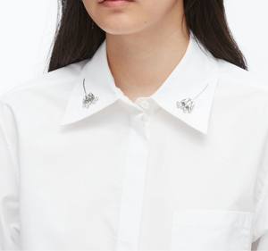 A person wears the 3.1 Phillip Lim Cropped Shirt with Embroidered Collar, crafted from technical poplin and adorned with silver collar embellishments.