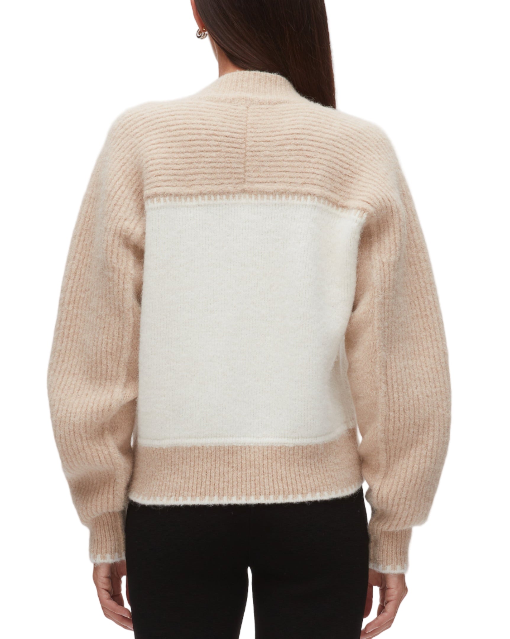 Someone is seen from the back wearing the 3.1 Phillip Lim Raglan Zip Cardigan in beige and white color block with long sleeves, paired with black pants.