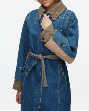 A woman wearing the 3.1 Phillip Lim Denim Combo Trench, which features a removable belt.