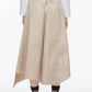 A person shown from the back against a plain background wears the 3.1 Phillip Lim Combo T-Shirt Dress, featuring beige cotton poplin with asymmetric draping, paired with brown socks and black shoes.