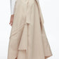 A person wearing the 3.1 Phillip Lim Combo T-Shirt Dress, featuring a beige cotton poplin skirt with asymmetric draping and a tied waist belt, paired with a white long-sleeve top.