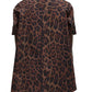 Person seen from the back wearing the Adam Lippes Trapeze Shirt Printed Poplin Leopard, a short-sleeve brown leopard print shirt in Italian cotton poplin, with black pants visible below the hem.