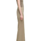 A person in profile wears the Adam Lippes Lamy Pant—a high-waisted, flared silhouette in beige Italian tropical wool—paired with a sleeveless taupe top, set against a white background.