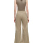 A person stands with their back to the camera, wearing the Adam Lippes Lamy Pant—wide-leg tailored beige pants—paired with a sleeveless brown top, creating a flared silhouette against a white background.