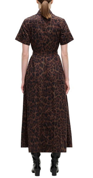 A person faces away, wearing the Adam Lippes Leighton Dress in brown and black leopard print Italian cotton poplin with a belt, paired with black boots and a ponytail.