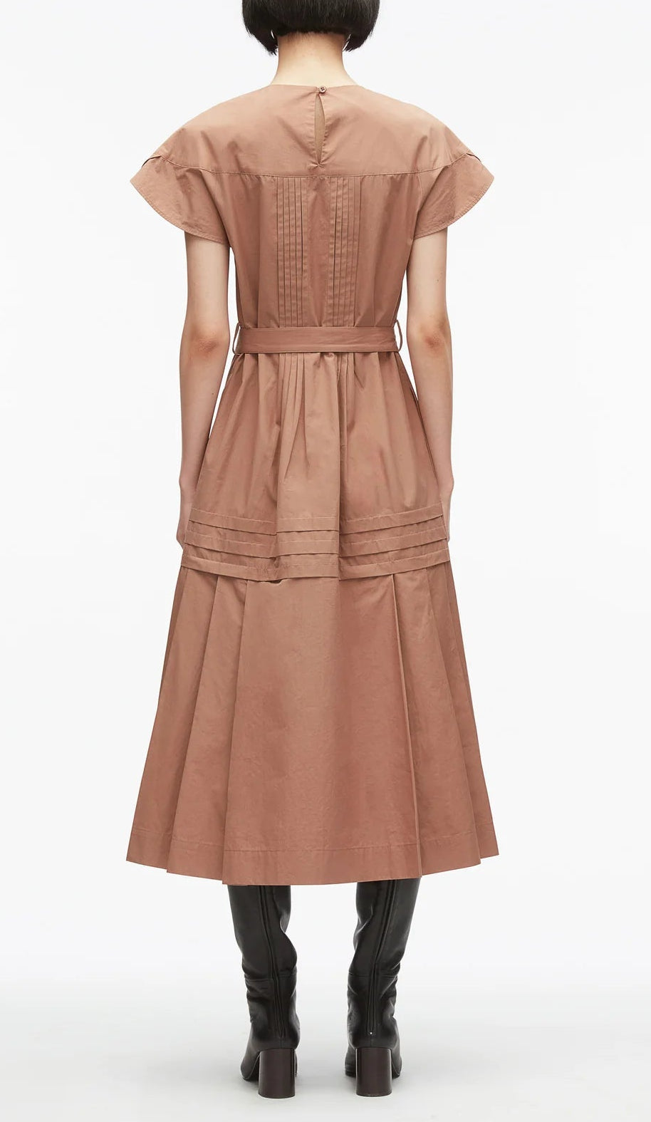 A person stands facing away, wearing the 3.1 Phillip Lim Pleated Poplin Tulip Sleeves Midi Dress with pintuck detailing, styled with black knee-high boots against a plain white background.