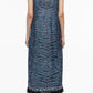 A person with short dark hair is wearing the 3.1 Phillip Lim Tiger Print Studded Midi Dress, paired with black boots and standing against a white background.
