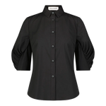 The Lela Rose Cotton Poplin Shirred Sleeve Shirt is a black button-up cotton poplin shirt with a collar and shirred, puffed three-quarter sleeves. It features a relaxed silhouette and is displayed against a plain white background.