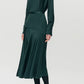 Person wearing the Blaine Silk Cashmere Top by Adam Lippes with black tights and white heels, standing against a plain light background.