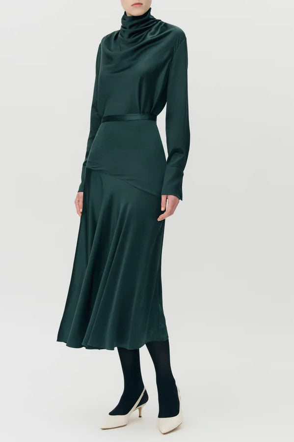 Person wearing the Blaine Silk Cashmere Top by Adam Lippes with black tights and white heels, standing against a plain light background.