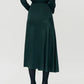 A person wearing the Adam Lippes Tess Silk Charmeuse Skirt with black tights and cream heels, standing against a plain light background.