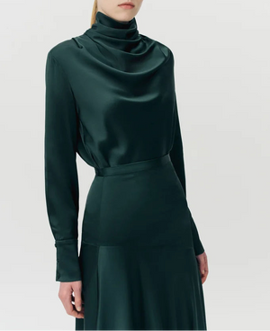 A person wearing the Adam Lippes Tess Silk Charmeuse Skirt, standing against a plain light background.