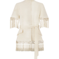 The Stretch Cotton Fringed Cape by Lela Rose features a cream hue, high collar, short sleeves, and fringe detailing at the sleeves and hem—drawing inspiration from western dressing while seamlessly blending classic flair with modern style.