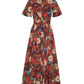 The Leighton Dress by Adam Lippes is a collared, short-sleeve, button-down cotton poplin dress with a tie waist and red floral print on a dark background.
