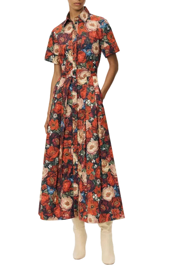 Wearing the Leighton Dress by Adam Lippes in Italian cotton poplin with a vibrant floral print, paired with light-colored calf-length boots.