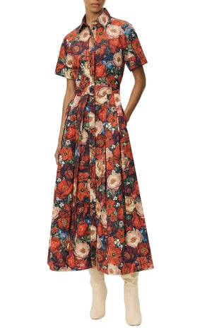 Wearing the Leighton Dress by Adam Lippes in Italian cotton poplin with a vibrant floral print, paired with light-colored calf-length boots.