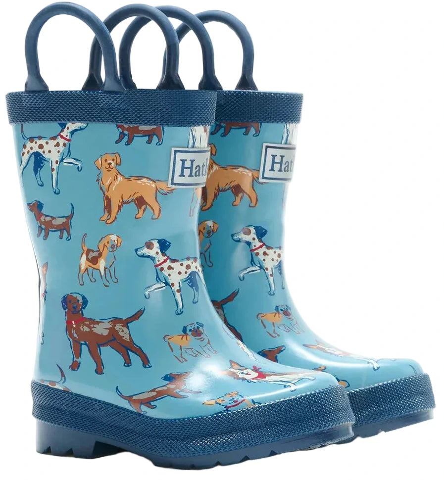 Hatley Blue Pups Rain Boots with Handles for kids feature a playful puppy print with illustrations of various dog breeds in different colors, along with blue handles for easy wearing.