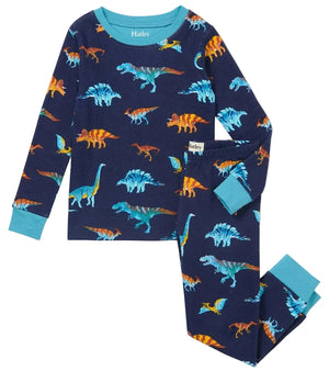 The Boys’ Colourful Dinos Cotton Rib Pajama Set by Hatley, featuring a navy blue base and light blue cuffs, is adorned with vibrant dinosaur prints and displayed flat against a white background. Made from soft organic cotton, these cozy pajamas offer sustainable and comfortable sleepwear for kids.