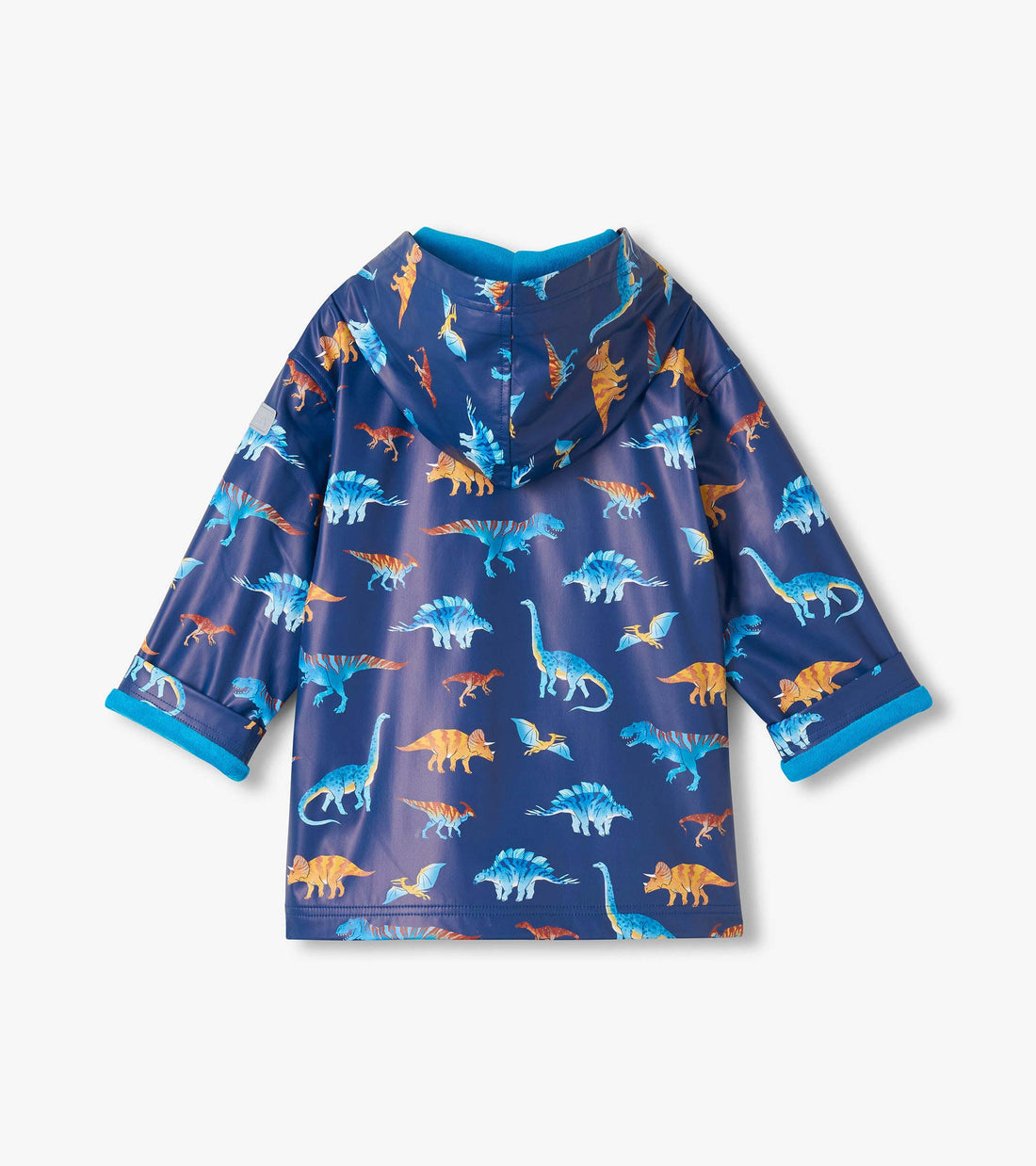 The Hatley Boys’ Colourful Dinos Rain Coat features a blue background with vibrant dinosaur prints, shown from the back with a hood and rolled cuffs.