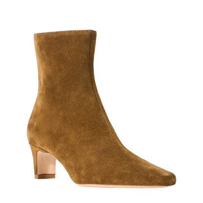 The Wally Suede Ankle Boot by Staud features brown suede, a mid-height block heel, and a pointed toe for an elevated, versatile everyday look, shown against a white background.