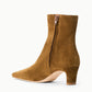 The Staud Wally Suede Ankle Boot features rich brown suede, a pointed toe, side zipper, and a mid-height block heel. Photographed against a plain white background, this effortlessly versatile boot is perfect for everyday wear.