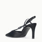 The Staud Inez Heel is a black slingback shoe with a pointed toe, a thin ankle strap, and a stiletto heel. It features an elastic back strap for added comfort and is photographed from the side against a plain white background.