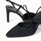 The Staud Inez Heel is a pair of black slingback heels with pointed toes, polished heels, and sophisticated crisscross strap detailing complemented by an elastic back strap for a secure fit—shown against a white background.