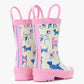 The Girls’ Little Pups Rain Boots by Hatley feature pink soles and trim, a slip-resistant design, and an illustrated pups print in shades of blue, pink, and purple on a white background. These adorable toddler boots are shown from the back and side.