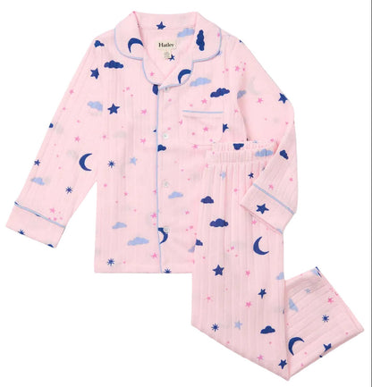 Hatley Girls’ Night Sky Relaxed Fit Pajama Set features long sleeves and pants made from soft brushed rib fabric, adorned with blue clouds, moons, stars, and pink star patterns for a cozy sleepwear set she’ll love.
