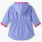 The Girls’ Pretty Bows Reveal Field Jacket by Hatley is shown from the back against a white background. This light purple periwinkle hooded jacket for girls features pink trim on the cuffs, an elastic waistband, a curved hem, and charming details that add both playful style and comfort.