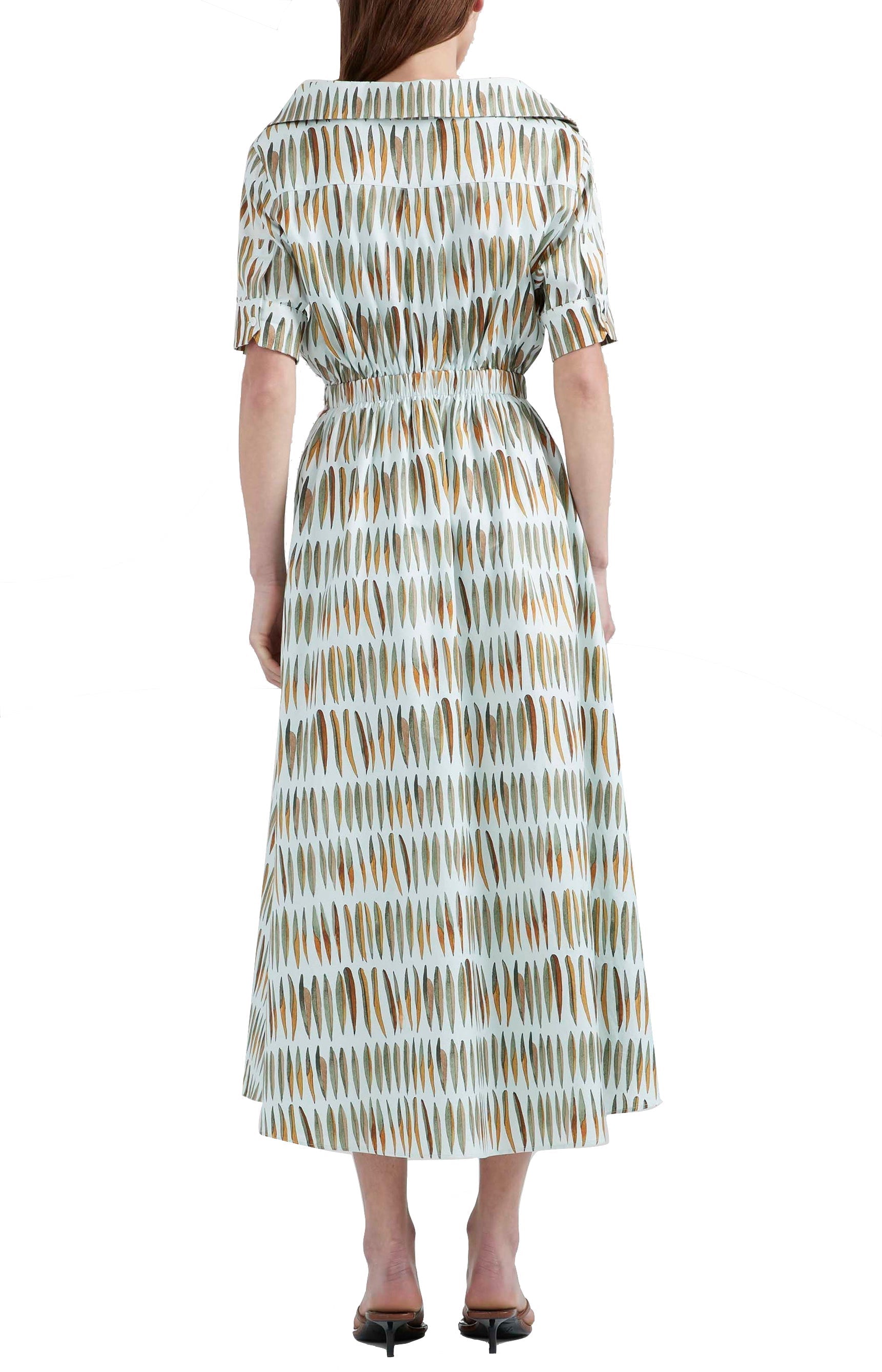 The Altuzarra Lydia Dress by Altuzarra features a midi silhouette, knee-length with short sleeves and a collared neckline. It is adorned with elongated vertical brown and white shapes and crafted from airy cotton poplin, showcasing a fitted waist with a gathered effect.