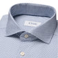 Close-up of a folded Slim Mid Blue Geometric Cotton Four-Way Stretch Shirt, crafted from performance fabric, with an "Eton" label inside the collar.