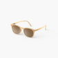 The IZIPIZI Kids’ #E Polarized Sunglasses feature a beige square frame and brown-tinted polarized lenses that provide UV protection. The lightweight sunglasses are shown on a white background, angled slightly to the left.