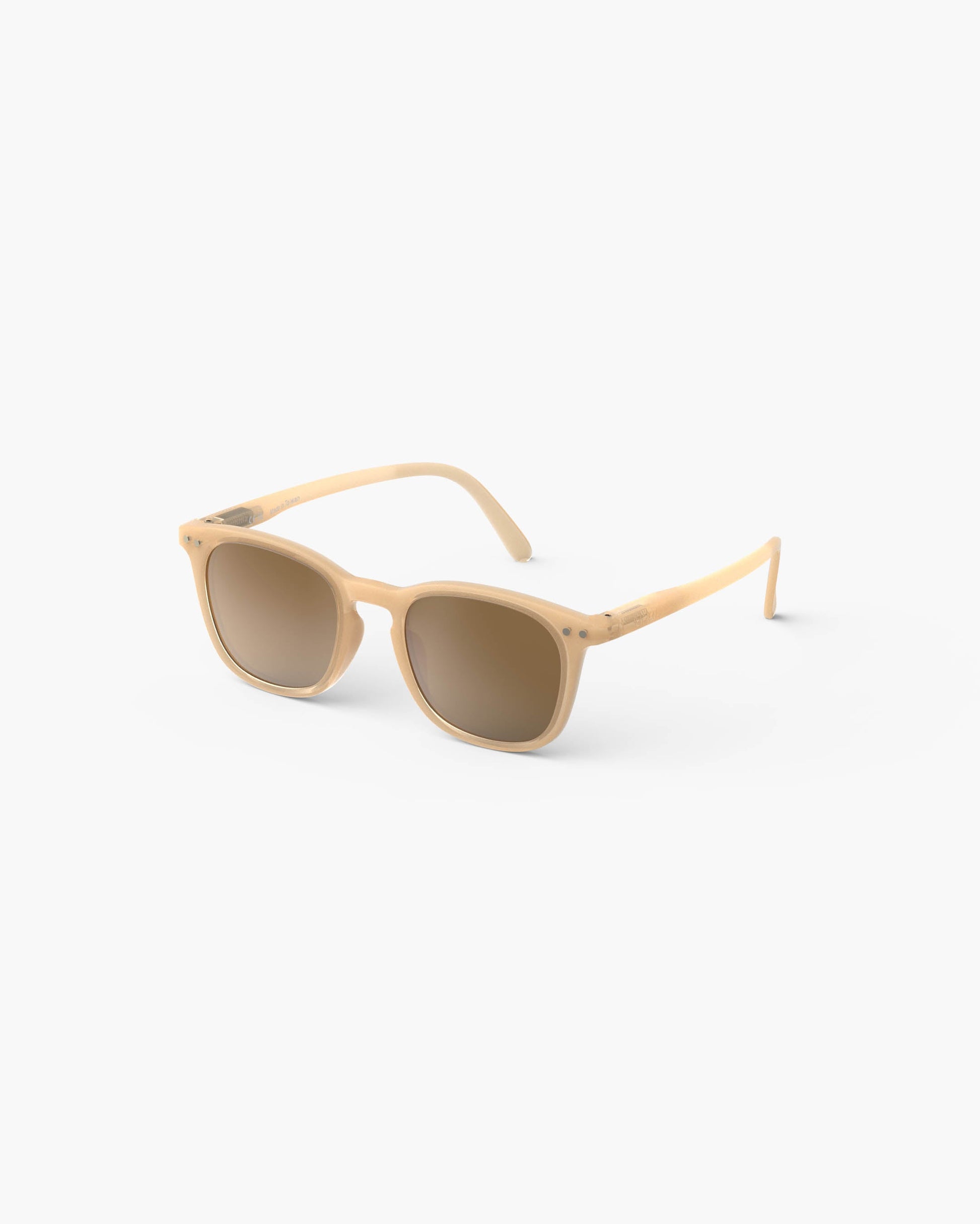 The IZIPIZI Kids’ #E Polarized Sunglasses feature a beige square frame and brown-tinted polarized lenses that provide UV protection. The lightweight sunglasses are shown on a white background, angled slightly to the left.