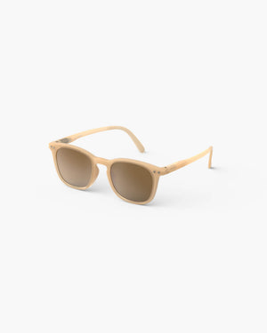 The IZIPIZI Kids’ #E Polarized Sunglasses feature a beige square frame and brown-tinted polarized lenses that provide UV protection. The lightweight sunglasses are shown on a white background, angled slightly to the left.