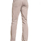 A person wearing Faherty's Movement Five Pocket Pant and a blue checkered shirt stands with their back to the camera, highlighting beige casual shoes. The pants' 4-way stretch fabric ensures comfort in every step, ideal for those on the move.