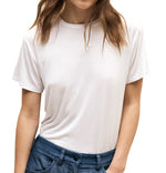 Woman wearing a TWP His Tee made from the softest jersey fabric and blue jeans.