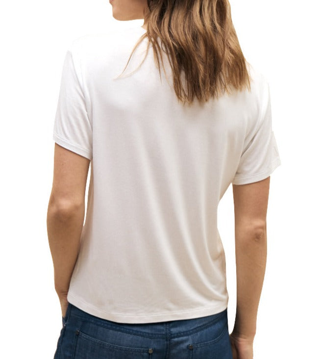 Woman seen from behind wearing a TWP His Tee made from the softest jersey fabric and blue jeans.