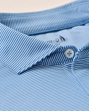 Close-up of the Johnnie-O Waverunner Polo, a men's blue and white striped collared shirt with buttons, highlighting the fabric's texture and pattern—this stretch polo offers UPF 50 protection and moisture-wicking properties for all-day comfort.