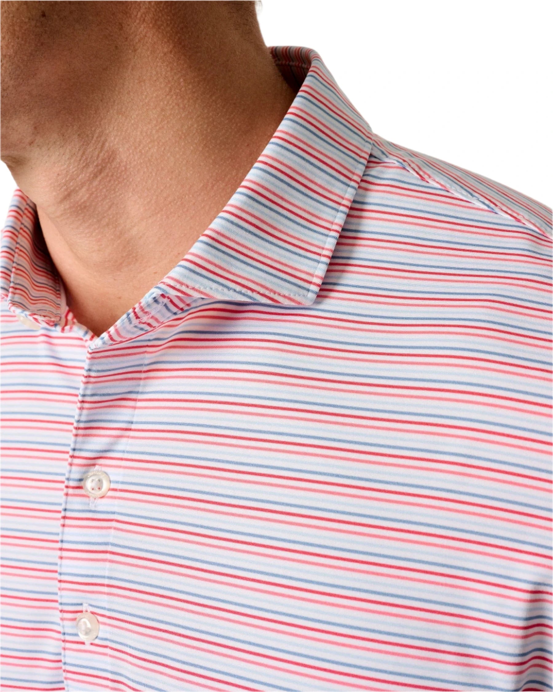 Close-up of a person wearing the Johnnie-O Kamdon Performance Jersey Polo, featuring horizontal red, white, and blue stripes with two visible white buttons. Its moisture-wicking fabric ensures cool, comfortable wear.