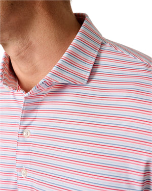 Close-up of a person wearing the Johnnie-O Kamdon Performance Jersey Polo, featuring horizontal red, white, and blue stripes with two visible white buttons. Its moisture-wicking fabric ensures cool, comfortable wear.