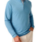 A man wearing a light blue Johnnie-O Motion Performance 1/4 Zip and beige pants, with one hand in his pocket.